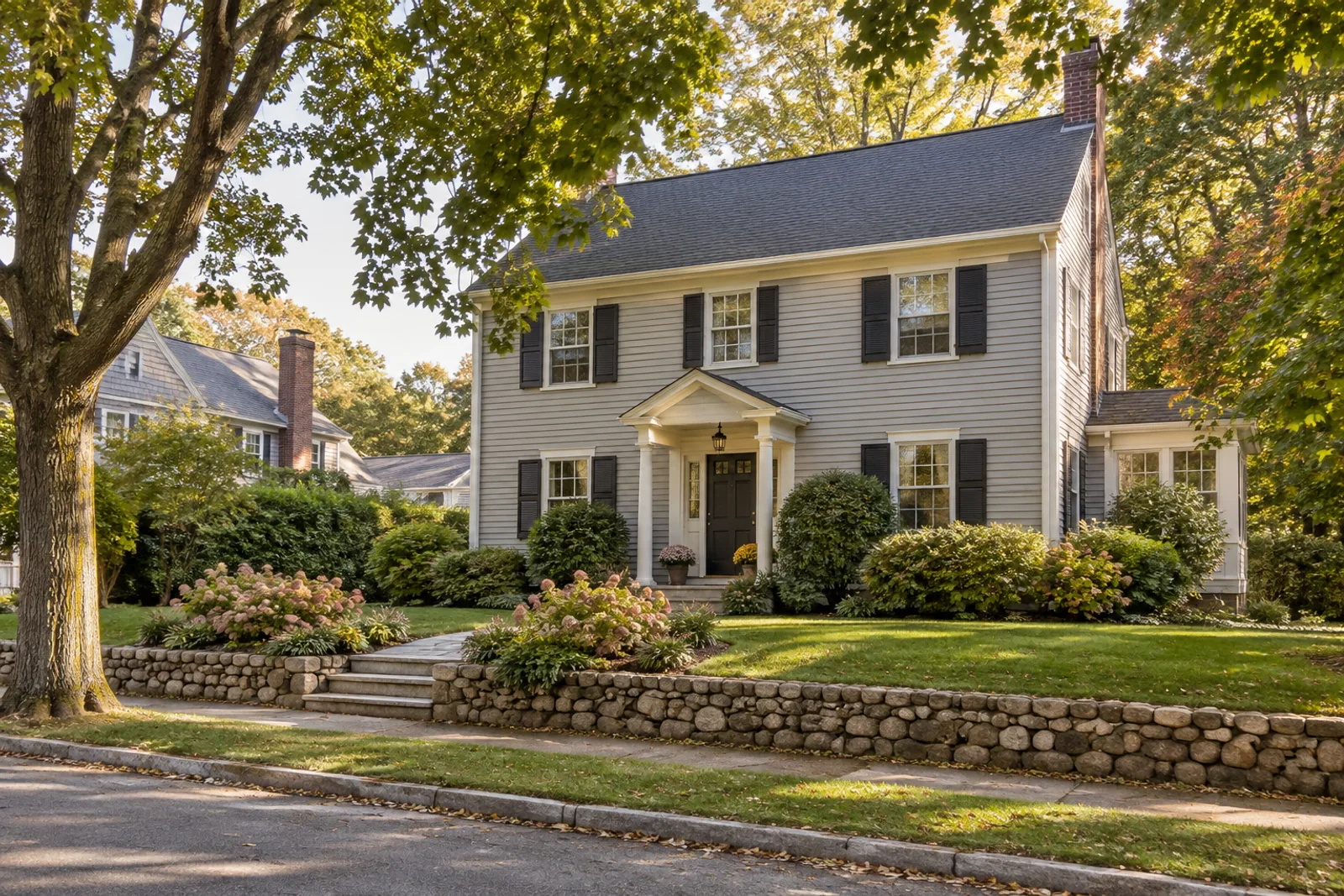 A traditional Wellesley-area colonial home on a green residential street.